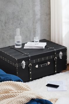 a black suitcase sitting on top of a white rug