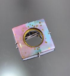 Modern opalescent kiln fired enamel with 24K gold in shades of blue, violet, golden pink and rose. Set into a sterling silver and 24K gold keum-boo back. Custom modified C clasp closure, 1.5" X 1.5". *please use contact form to request additional information or photos, thanks! Luxury Silver Enamel Brooches, Luxury Enamel Wedding Brooches, Luxury Enamel Cabochon Jewelry, Luxury Enamel Brooch Jewelry, Luxury Enamel Brooch As A Gift, Luxury Cabochon Enamel Jewelry, Luxury Fusion Enamel Jewelry, Luxury Silver Enamel Jewelry, Luxury Handmade Enamel Brooches