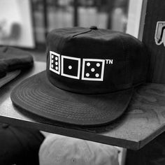 IYKYK. A black and white Nashville hat at its best. If you're looking to represent the 615 in an understated and clever way, this classic 6-Panel Snapback Flat bill ⚅⚀⚄ᵀᴺ is perfect. Black, peached twill and adjustable snapback for a comfortable fit with a raised white rubber dice design on the front panel. The modern dice are clean & minimal which are strong enough to stand on their own... but when you see it, this design gets even better. Definite conversation starter. Description Color: Black Retro Black Cotton Snapback Hat, Retro Adjustable Black Snapback Hat, Classic Adjustable 5-panel Trucker Hat, Retro Black Six-panel Baseball Cap, Classic 5-panel Hats For Streetwear, Vintage Black 5-panel Hat, Classic 5-panel Trucker Hat For Streetwear, Classic Adjustable 5-panel Snapback Hat, Urban 5-panel Hats For Skateboarding