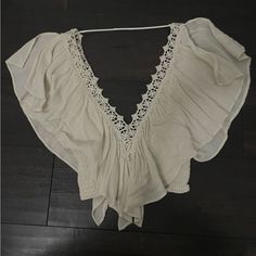 Embroidered Trim Beige Floral Embroidery Tops For Beach, Beige Floral Embroidered Tops For Beach, Chic Embroidered Tops For Vacation, Embroidered Tops For Beach, Spring Festival Top With Crochet Trim, Chic Floral Embroidery Blouse For Beach, Embroidered Bohemian Tops For Beach Season, Bohemian Embroidered Tops For Beach Season, Embroidered Beige Tops For Vacation