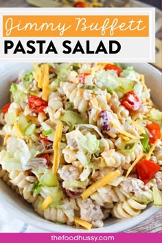 a bowl filled with pasta salad on top of a table