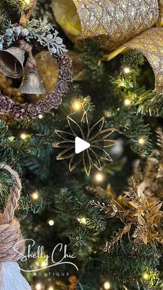 a christmas tree decorated with gold and silver decorations, bells and ornaments hanging from it's branches