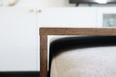 a close up view of a chair with a clock in the background