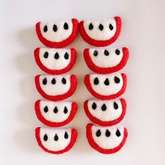 there are six red and white buttons with black dots on them in the shape of teeth