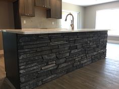 a kitchen island made out of black stone