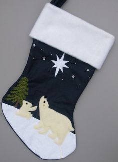 a christmas stocking with polar bears on it and a star above the stocking