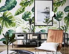 a living room filled with furniture and wallpaper covered in green leaves