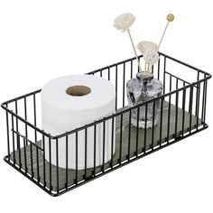 two rolls of toilet paper are in a black basket with metal handles and one roll is on top of the other