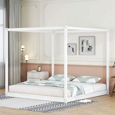 a white bed sitting on top of a wooden floor