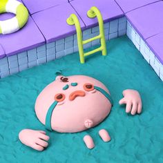 a cake in the shape of a cartoon character laying on top of a swimming pool