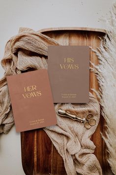 two book covers sitting on top of a wooden tray next to a pair of scissors