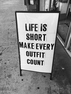 a sign that says life is short make every outfit count