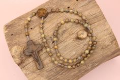 +. Peace be with you. +.Wooden rosary necklace The cross, centerpiece as well as the beads, are constructed of wood.  +.Fragrant Wood -Lignum Vitae There is a wood called ''Lignum Vitae"  It has the meaning of 'a tree that heals wounds'.  It is a sacred tree also called the 'tree of life' and 'green heart'.   The tree grows very slowly, making it one of the hardest woods.   It is even called 'iron wood'. The reason why 'lignum vitae' is called these names is because of the perfume oil    (oil wi Handmade Crucifix Rosary For Meditation, Wooden Beads Rosary With Crucifix As Gift, Gift Rosary With Wooden Beads And Crucifix, Handmade Cross Rosary For Blessings, Handmade Brown Crucifix Rosary, Knotted Rosary, Lignum Vitae, Wooden Rosary, Sacred Tree