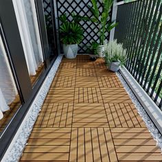 a small balcony with potted plants on the side and wooden flooring next to it