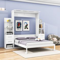 a white bed sitting next to a book shelf on top of a hard wood floor