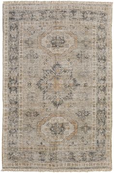 an antique rug with many different colors and patterns on the carpet, including beiges, browns