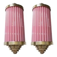 two pink candles sitting next to each other