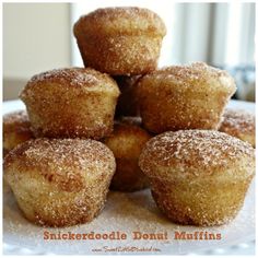 a pile of sugared donut muffins sitting on top of a white plate