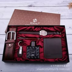 an open gift box containing men's items including a watch, belt and wallet