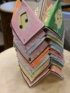 a stack of folded money sitting on top of a wooden table next to a chair