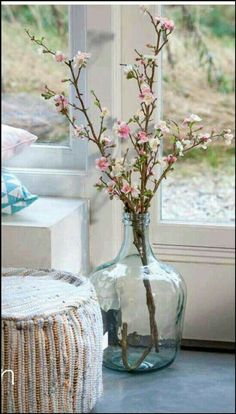 a vase filled with flowers next to a window