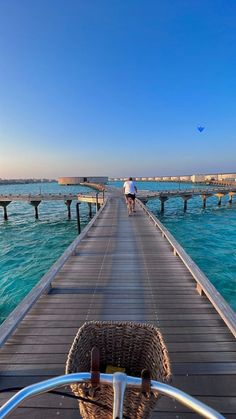 a person riding a bike on a pier