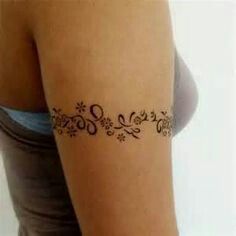 a woman's arm with a tattoo on it that has flowers in the middle