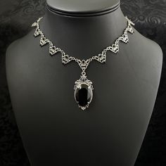 "This elegantly ornate necklace is made with antique silver tone centerpieces, featuring filigree and leaf details. Its mesmerizing design is accented with dazzling jet black glass crystals with a large high quality faceted jewel hanging at its center.  Decorated portion is 8 1/2\" wide and 2 1/4\" tall in the very center.  Necklace length is adjustable with soldered stainless steel cable chain, lobster clasp and extender. If you would like a different length, please send us a message. If you don't see items with a color you want, feel free to ask about availability." Ornate Formal Necklace With Oxidized Finish, Formal Silver Filigree Bridal Necklace, Silver Filigree Bridal Necklace For Formal Occasions, Formal Antique Silver Necklace With Intricate Design, Gothic Filigree Metal Jewelry, Gothic Filigree Pendant Jewelry, Gothic Sterling Silver Jewelry With Intricate Design, Antique Silver Necklace With Intricate Design For Formal Occasions, Gothic Antique Silver Jewelry With Intricate Design