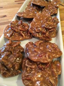 chocolate covered cookies on a white platter sitting on a wooden counter top, ready to be eaten