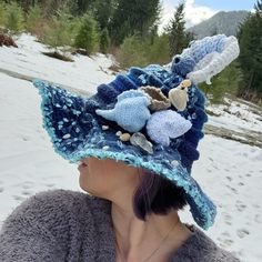 This gorgeous one-of-a-kind wearable art piece is perfect for anything your imagination can dream up! This hand-crocheted and embellished slouchy witch hat is perfect for cosplay, Halloween,  or any other occasion you desire.  This hat is called "Moonlit Sea" and has crocheted shells alongside real shells,  a beautiful pearl tucked inside the crocheted clamshell, delicate beads embellishing the crocheted shells for some sparkle,  as well as glass moon and star beads scattered around the hat for extra twinkle.  You are guaranteed to get ooh's and aah's every time you wear this beautiful hat! (message me to inquire about the creation of a custom hat if you prefer that instead) Whimsical Handmade Beach Hats, Handmade Whimsical Crochet Hat, Handmade Bohemian Costume Hat With Curved Brim, Handmade Beach Costume Hats And Headpieces, Handmade Bohemian Hat With Curved Brim, Unique Handmade Wide Brim Costume Hat, Whimsical Yarn Beach Hat, Whimsical Yarn Hats For The Beach, Handmade Yarn Costume Hat