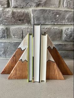 a book holder made out of wood with two books in the shape of a christmas tree