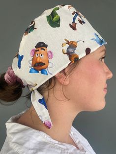 Toy Story Scrub Cap - handmade from 100% cotton fabric and is fully lined. The elastic back with ties are adjustable for a more comfortable fit. UNISEX DESIGN  Pattern placement may vary Sizes:  S-M Fits most approx 58cm diameter M-L Fits most and those with longer hair approx 60cm diameter CARE INSTRUCTIONS Warm Hand wash or cool machine wash on gentle cycle. DO NOT tumble dry or dry clean. Adjustable White Cotton Bandana, Surgeon Cap Pattern, Diy Surgical Cap, Adjustable Multicolor Cotton Bandana, Dental Scrub Cap, Longer Hair, Surgical Scrub Hats, An Elf, Surgical Caps