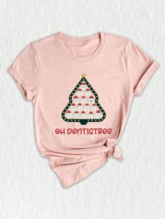 Celebrate the festive season with our delightful **Oh Dentistree Shirt**! This unique **Holiday Shirt** is perfect for dental professionals and enthusiasts alike, making it an ideal **Gift For Dentist**. Whether you're shopping for a **Dentist Student** or a seasoned pro, this shirt is sure to bring smiles all around. Adorned with whimsical **Funny teeth** illustrations, the design cleverly combines a love for dentistry and Christmas, embodying the spirit of the season. The **Christmas Dentist** theme shines through with vibrant colors and fun elements, making it a standout addition to any holiday wardrobe. Perfect for holiday parties or cozy family gatherings, this shirt is a great way to show off your pride in the **Dentist Life** while celebrating with style. Pair it with your favorite Dental Christmas Shirts, Dentist Shirt Ideas, Holiday Dental Office Shirts, Dentist Student, Dental Office T Shirt Ideas, Dental Puns, Dental Assistant Tshirts, Dental Shirt, Gift For Dentist