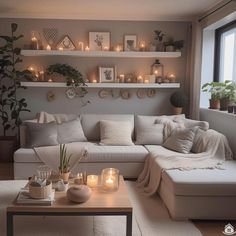 a living room filled with lots of furniture and candles on the shelves above it's couch