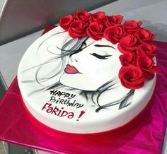 a birthday cake decorated with red roses and a drawing of a woman's face