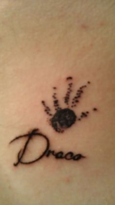 a small tattoo on the back of a woman's shoulder that says, dance