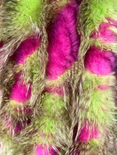 the fur is multicolored and has been dyed pink, green, and yellow