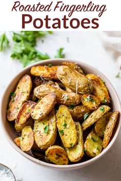 roasted fingerling potatoes in a bowl with parsley on the side and text overlay