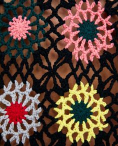 crocheted doily with multicolored flowers on it