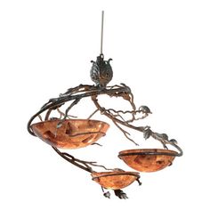 a chandelier with three birds hanging from it's branches and two bowls on the bottom