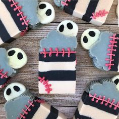 decorated cookies are arranged in the shape of baseballs and bats on a wooden table