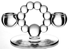 a glass candle holder with balls in it