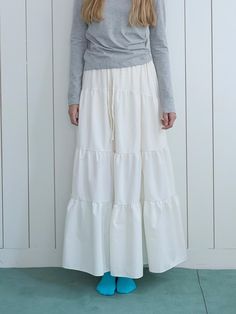 Color: WHITECountry of Origin : Republic of Korea Spring Cotton Bottoms With Layered Hem, Spring Cotton Ruffled Skirt, Cotton Ruffled Skirt For Spring, Chic Off White Tiered Skirt, Cotton Skirt With Layered Hem, Off White Relaxed Fit Skirt For Spring, Off White Relaxed Skirt For Spring, Spring Off White Tiered Skirt, Off White Tiered Skirt For Spring