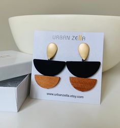 "Big Bold Statement Earrings, Matte Gold Earrings, Black Earrings Ultra modern earrings, clean cut design to complement any outfit. Very Light weight. Materials: Gold plated brass, Rubberized acrylic beads, wood beads. Size: 2\" Long, 1.5\" Wide Your purchase comes in a beautiful box that is ready to give as a gift or to keep for yourself. **Want a custom design? Just ask! The custom made jewelry is sure to make the owner feel like a super star. We love mixing finishes. **Please be sure to read Modern Black Geometric Earrings, Modern Brown Drop Earrings, Matte Gold Earrings, Contemporary Earrings, Earrings Geometric, Ultra Modern, Super Star, Earrings Black, Black Earrings