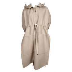 Oversized oatmeal wool coat with hood designed by Phoebe Philo for Celine dating to resort of 2016. French size 36 however this coat has a very oversized fit. Approximate measurements: drop shoulder 23", bust 46", arm length 22" and overall length at center back 39" (sides draped a few inches longer). Silver hardware. Zip closure. Patch pockets. Made in Italy. Fabric content: 95% wool and 5% cashmere with 100% cotton trim. Very good condition. Coat With Hood, Gucci Logo, Phoebe Philo, Cashmere Coat, Hooded Coat, Outerwear Coats, Wool Coat, Silver Hardware, Drop Shoulder