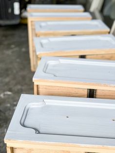 several empty wooden trays lined up on top of each other