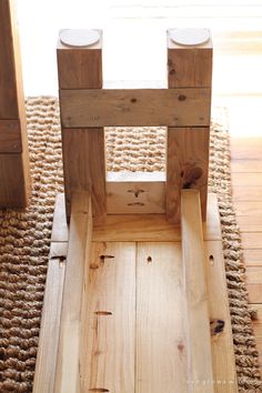 a wooden chair sitting on top of a rug