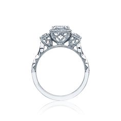 an engagement ring with three stones on the side and two diamonds on the top, set in