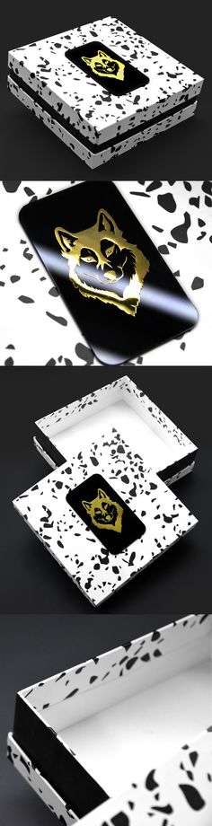 three different boxes with black and white designs on the front, one in gold foil