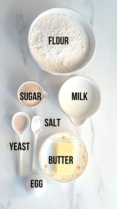 ingredients to make an egg cake laid out on a white marble counter top with the words flour, sugar, salt, butter, and eggs